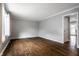 Bright, freshly painted living room with hardwood floors and ample natural light through a large front window at 156 Aspen Way, Carmel, IN 46032