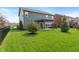 Spacious backyard features a well-manicured lawn, trees, and a covered patio, ideal for outdoor entertaining and relaxation at 15723 Myland Dr, Noblesville, IN 46062