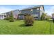 Well-maintained backyard with lush green lawn, young trees and an entertainment space with pergola for outdoor relaxation at 15723 Myland Dr, Noblesville, IN 46062