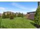 Well-manicured backyard with lush greenery and a pergola-covered patio, ideal for relaxation and entertaining at 15723 Myland Dr, Noblesville, IN 46062