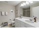 Well-lit bathroom with double vanity, framed mirror, and glass-enclosed shower, designed for comfort and style at 15723 Myland Dr, Noblesville, IN 46062