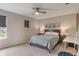 Cozy bedroom with neutral walls, carpet, ceiling fan, and a window offering natural light at 15723 Myland Dr, Noblesville, IN 46062