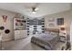 Comfortable bedroom with a ceiling fan, large windows, and a decorative shelving unit at 15723 Myland Dr, Noblesville, IN 46062