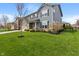 Attractive two-story house featuring a large front lawn, mature landscaping, and a welcoming entrance at 15723 Myland Dr, Noblesville, IN 46062