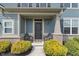 Inviting front porch with seating, enhanced by lush landscaping and a welcoming entrance at 15723 Myland Dr, Noblesville, IN 46062