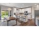 Modern kitchen with white cabinetry, stainless steel appliances, a wooden table and a stylish lighting fixture at 15723 Myland Dr, Noblesville, IN 46062