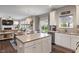 Well-designed kitchen with stainless steel appliances, white cabinetry, a kitchen island, and hardwood floors at 15723 Myland Dr, Noblesville, IN 46062
