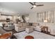 Open-concept living space with hardwood floors and a comfortable sectional, seamlessly connecting to the dining area at 15723 Myland Dr, Noblesville, IN 46062