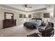 Spacious main bedroom featuring tray ceilings, a large bed, and ample natural light, creating a serene retreat at 15723 Myland Dr, Noblesville, IN 46062