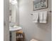 Elegant powder room with pedestal sink, stylish mirror, and neutral tones, perfect for guests at 15723 Myland Dr, Noblesville, IN 46062