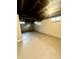 Spacious basement with painted walls and ceiling, offering potential for various uses at 1624 N Whittier Pl, Indianapolis, IN 46218