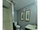 Clean and functional bathroom with a shower stall, toilet, vanity, and decorative artwork at 1624 N Whittier Pl, Indianapolis, IN 46218