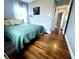 Cozy bedroom with hardwood floors, a comfortable bed, and natural light at 1624 N Whittier Pl, Indianapolis, IN 46218