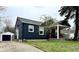 Inviting home exterior featuring a well-kept lawn and a detached garage at 1624 N Whittier Pl, Indianapolis, IN 46218