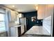 Charming kitchen featuring white cabinetry, a granite countertop, and stainless steel appliances at 1624 N Whittier Pl, Indianapolis, IN 46218
