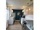 Bright kitchen with white cabinets, stainless appliances, and stylish breakfast bar with stools at 1624 N Whittier Pl, Indianapolis, IN 46218