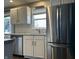 Well-lit kitchen featuring white cabinets, subway tile backsplash, and stainless steel appliances at 1624 N Whittier Pl, Indianapolis, IN 46218