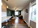Open concept view of the living room, featuring hardwood floors and updated furniture at 1624 N Whittier Pl, Indianapolis, IN 46218