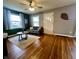 Bright living room featuring hardwood floors, a ceiling fan, and a modern sofa at 1624 N Whittier Pl, Indianapolis, IN 46218