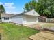 Backyard showcasing the detached garage, shed, concrete patio, and fire pit area at 1629 N K St, Elwood, IN 46036