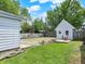 Backyard view showcasing the shed and the adjacent yard areas divided by a fence at 1629 N K St, Elwood, IN 46036