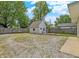 Large backyard with shed, wooden fence, a fire pit, and plenty of space for outdoor activities at 1629 N K St, Elwood, IN 46036