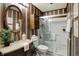 Bathroom featuring a vanity, oval mirror, and a walk-in shower with glass doors at 1629 N K St, Elwood, IN 46036