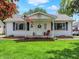 Charming single-story home with a well-maintained lawn and inviting front porch area with an American flag at 1629 N K St, Elwood, IN 46036