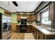Well-lit kitchen boasts wooden cabinets, stainless steel appliances, and a double basin sink at 1629 N K St, Elwood, IN 46036