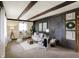 Comfortable living room features beamed ceilings, wooden wall accents, and neutral-toned furniture at 1629 N K St, Elwood, IN 46036