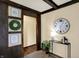 Elegant living room detail highlighting wood accents, decor and a large clock at 1629 N K St, Elwood, IN 46036
