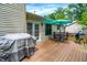 Back deck with dining set and grill alongside house with awning over door at 1697 Stacy Lynn Dr, Indianapolis, IN 46231