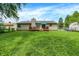Expansive backyard with a well-maintained lawn, deck, and a charming single-Gathering home at 1697 Stacy Lynn Dr, Indianapolis, IN 46231