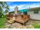 Wooden deck leading to a grassy backyard with mature trees at 1697 Stacy Lynn Dr, Indianapolis, IN 46231