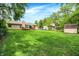 Spacious backyard featuring lush greenery and a shed near a charming single-Gathering home at 1697 Stacy Lynn Dr, Indianapolis, IN 46231