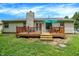Back of house featuring a wooden deck with access to a lush green lawn at 1697 Stacy Lynn Dr, Indianapolis, IN 46231