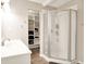 Bright bathroom with a glass-enclosed shower and open shelving for storage at 1697 Stacy Lynn Dr, Indianapolis, IN 46231
