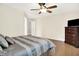 Bedroom features a ceiling fan, hardwood floors, dresser and closet door at 1697 Stacy Lynn Dr, Indianapolis, IN 46231