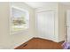Bedroom with wood floors, closet, and a bright window letting in natural light at 1697 Stacy Lynn Dr, Indianapolis, IN 46231