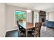 Dining area with wood table, backyard views, and flows into the living room at 1697 Stacy Lynn Dr, Indianapolis, IN 46231