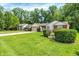 Lovely single-story home with mature landscaping, an attached garage and a spacious front yard at 1697 Stacy Lynn Dr, Indianapolis, IN 46231