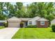 Charming single-story home with a well-manicured lawn and attached two-car garage at 1697 Stacy Lynn Dr, Indianapolis, IN 46231