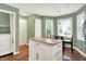 Green kitchen area with butcher block island, table and chairs and doorway to laundry room at 1697 Stacy Lynn Dr, Indianapolis, IN 46231