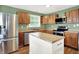Well-lit kitchen with wooden cabinets, stainless steel appliances, and a butcher block island at 1697 Stacy Lynn Dr, Indianapolis, IN 46231