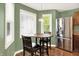 Cozy kitchen nook featuring a wood table, seating, and stainless steel refrigerator with natural light at 1697 Stacy Lynn Dr, Indianapolis, IN 46231