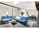 Spacious living room with large blue sectional, skylights, and open floor plan at 1697 Stacy Lynn Dr, Indianapolis, IN 46231