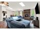 Comfortable living room with hardwood floors, a brick fireplace, a large sectional sofa and access to the dining room at 1697 Stacy Lynn Dr, Indianapolis, IN 46231