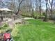 Well-maintained backyard featuring a lush lawn, mature trees, and a deck area perfect for outdoor activities and relaxation at 1737 Friendship Dr, Indianapolis, IN 46217
