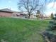Well-manicured backyard with mature trees, lush lawn, and beautiful landscaping creating a private outdoor space at 1737 Friendship Dr, Indianapolis, IN 46217