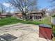 Expansive backyard featuring a basketball court, fenced yard, and screened porch for entertainment and outdoor enjoyment at 1737 Friendship Dr, Indianapolis, IN 46217